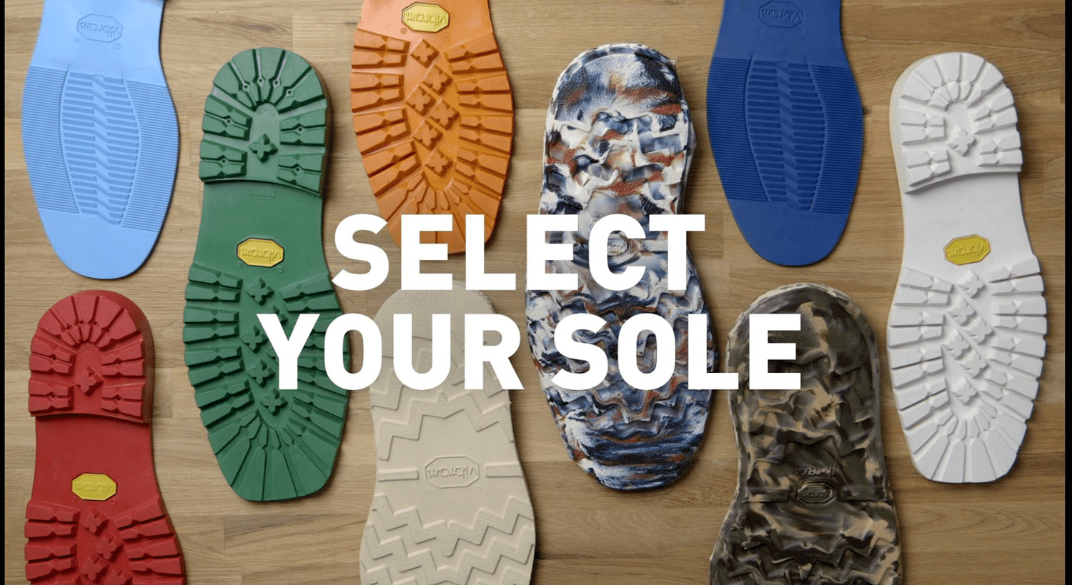 Multiple colorful shoe soles arranged on a wooden surface with the text 'Select Your Sole' overlaid.