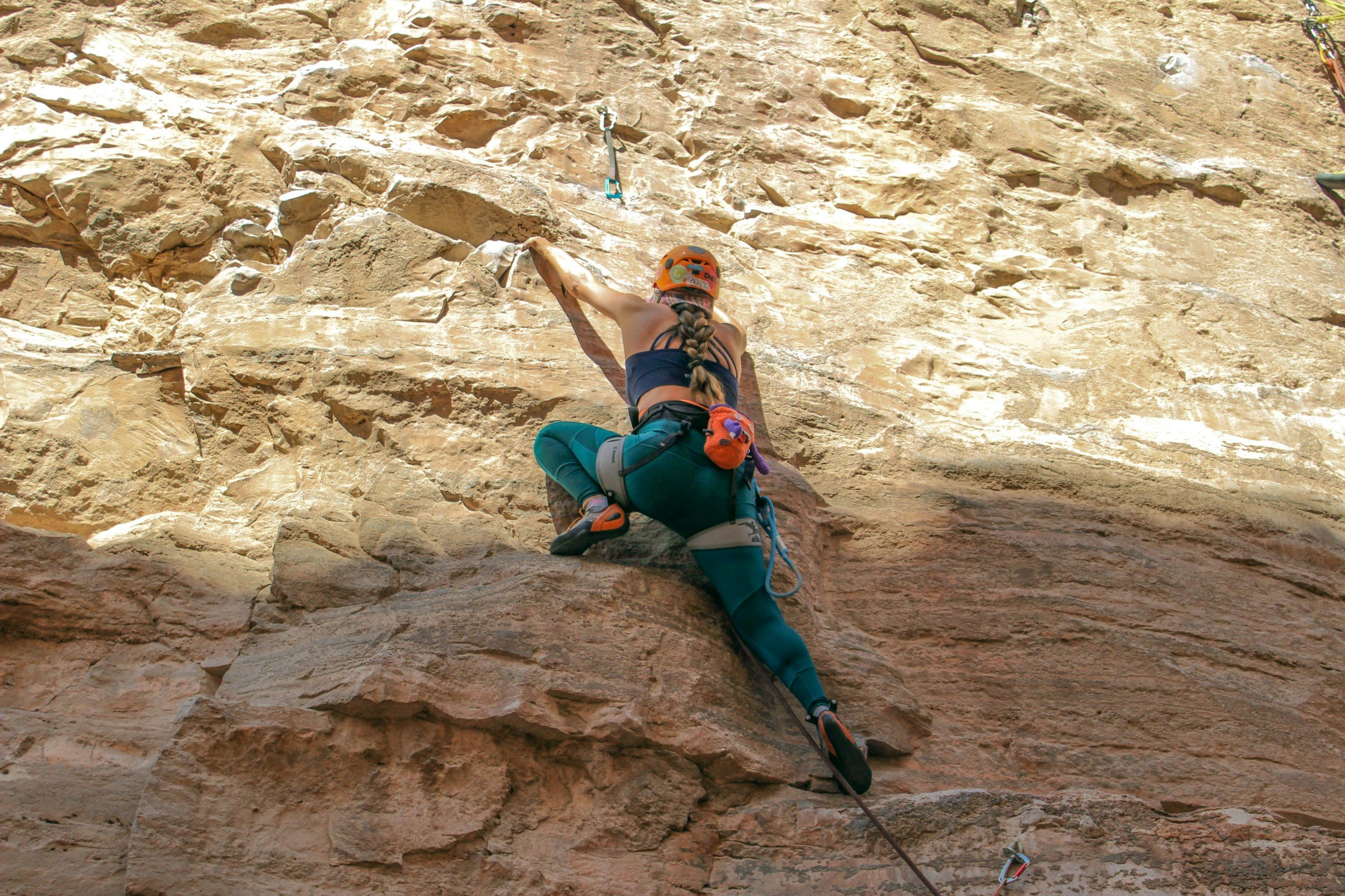 Climber on a rock face wearing climbing shoes